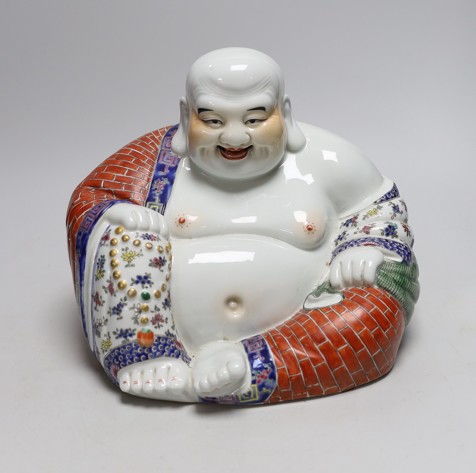 A Chinese famille rose figure of Budai, 23cm tall